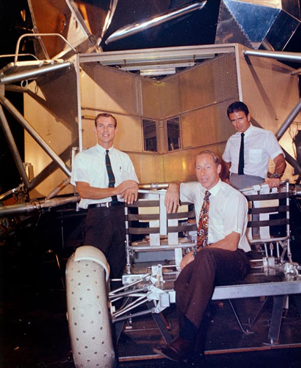 Photo of Al Worden, center, Dave Scott, left, and Jim Irwin with a moon rover mock-up