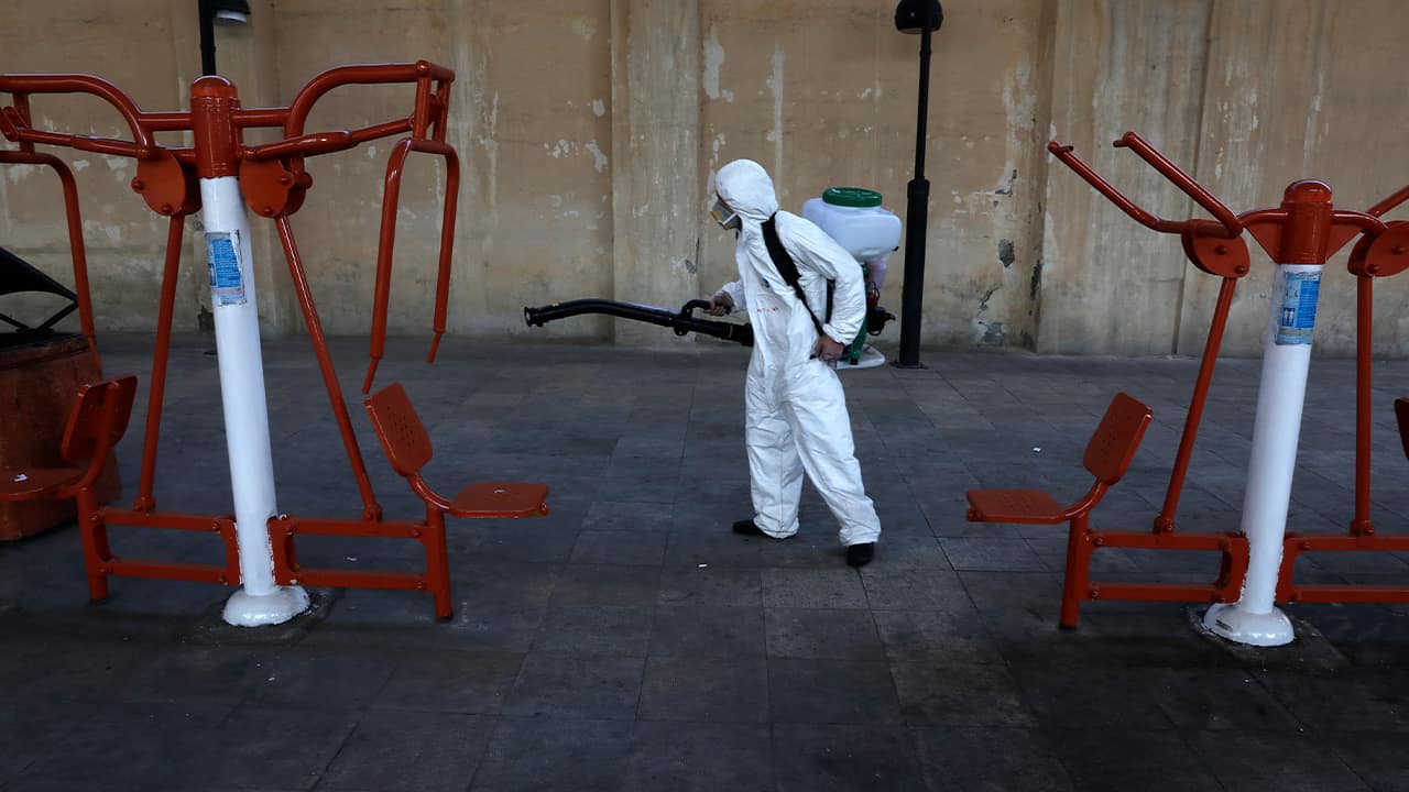 Photo of a firefighter disinfecting equipment in Tehran, Iran