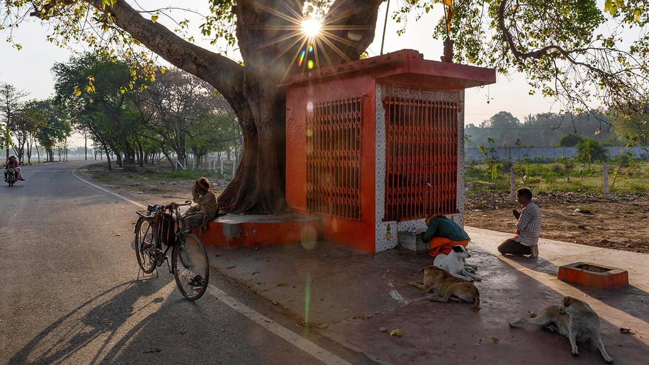 Photo of people outside a roadside Hindu temple in India