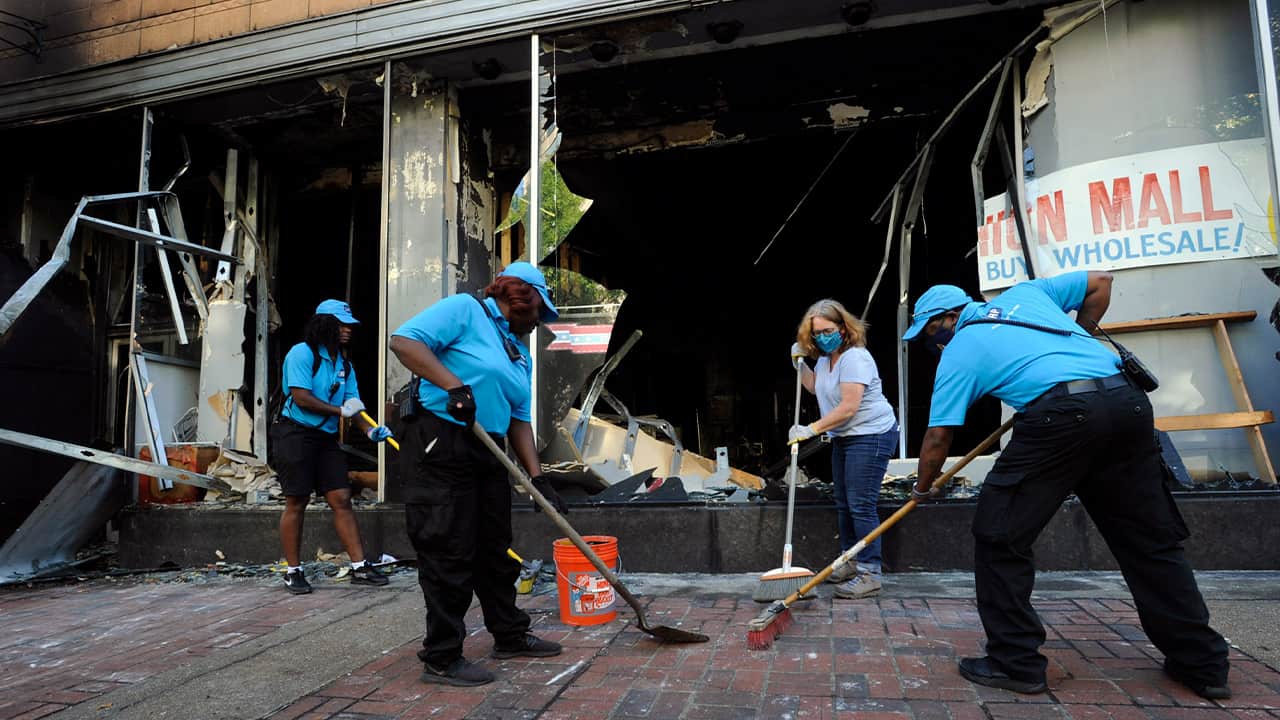 Photo of people cleaning up the damage in Alabama
