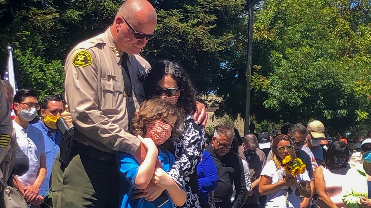 Photo of a sheriff with his wife and daughter
