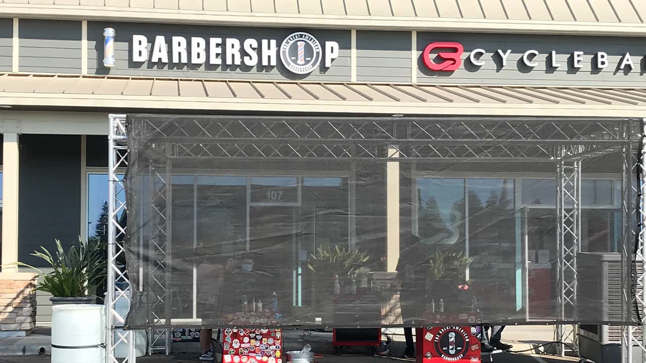 Photo of a customer getting a haircut outdoors during the pandemic in Fresno, California