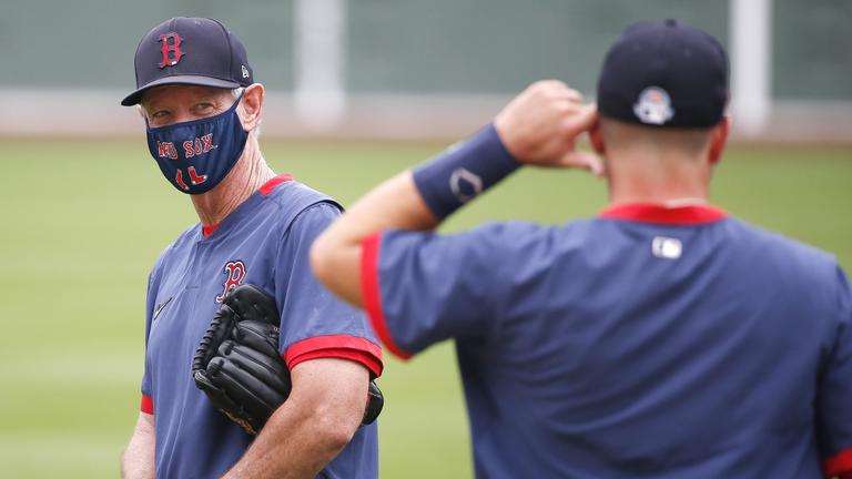 Photo of Red Sox manager Ron Roenicke wearing a team emblem face mask